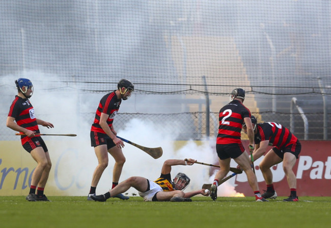 niall-deasy-is-tackled-as-a-flare-is-thrown-onto-the-pitch-behind-him