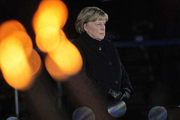 berlin-germany-02nd-dec-2021-chancellor-angela-merkel-cdu-stands-on-the-podium-during-her-farewell-by-the-bundeswehr-chancellor-merkel-bid-farewell-with-a-grand-taps-ceremony-at-the-bendlerbloc