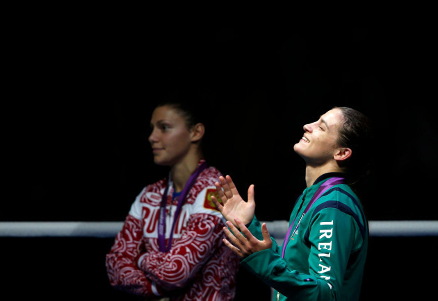 gold-medallist-katie-taylor-of-ireland-looks-up-as-silver-medallist-sofya-ochigava-of-russia-looks-on-during-the-medal-ceremony-for-the-womens-light-60kg-boxing-competition-at-the-london-olympic-ga