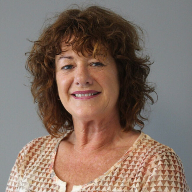 Headshot of Helen Browne - wearing a brown patterned top.