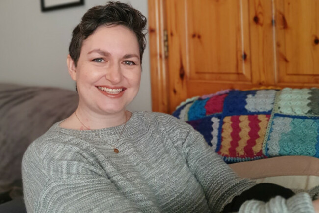 Edwina Hayes - wearing a grey jumped and necklace - in her sitting room.