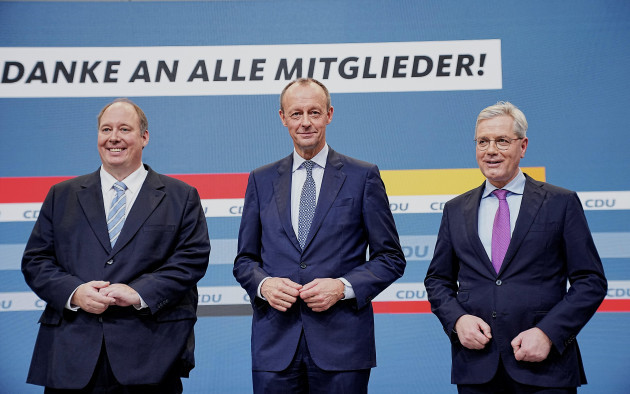 berlin-germany-17th-dec-2021-friedrich-merz-cdu-m-stands-between-the-co-candidates-for-the-party-chairmanship-helge-braun-cdu-l-and-norbert-rottgen-cdu-under-the-slogan-thank-you-to-all-m