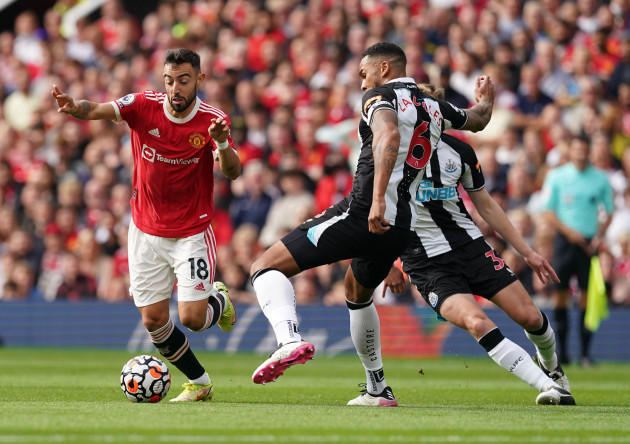 manchester-uniteds-bruno-fernandes-and-newcastle-uniteds-jamaal-lascelles-battle-for-the-ball-during-the-premier-league-match-at-old-trafford-manchester-picture-date-saturday-september-11-2021