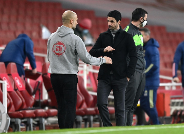 manchester-city-manager-pep-guardiola-left-and-arsenal-manager-mikel-arteta-after-the-final-whistle-during-the-premier-league-match-at-the-emirates-stadium-london-picture-date-sunday-february-21