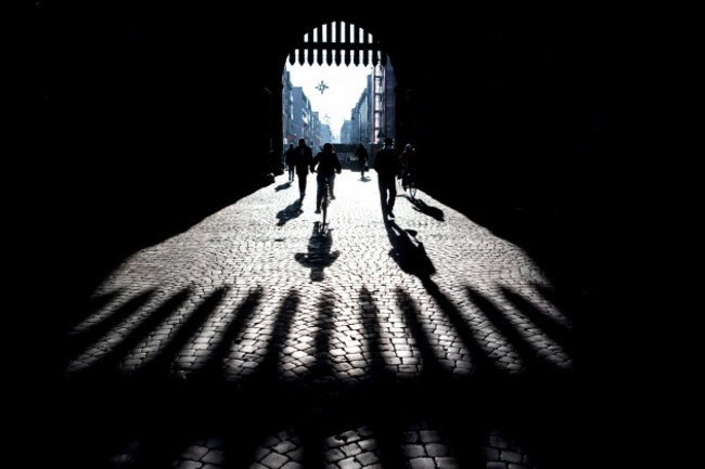 cologne-germany-13th-jan-2022-passers-by-cast-shadows-on-the-pavement-near-the-eigelstein-torburg-in-the-morning-mostly-gray-and-cloudy-in-the-afternoon-sunny-in-some-areas-according-to-meteoro