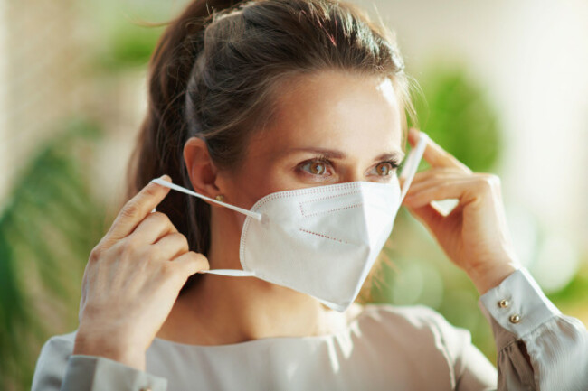 covid-19-pandemic-middle-aged-woman-in-grey-blouse-wearing-ffp2-mask