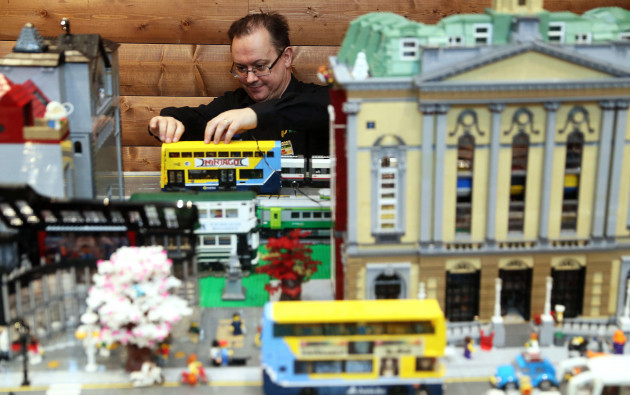 david-fennell-adjusts-a-model-dublin-bus-on-a-dublin-street-model-at-brickxfest-an-event-for-lego-enthusiasts-at-tayto-park-co-meath
