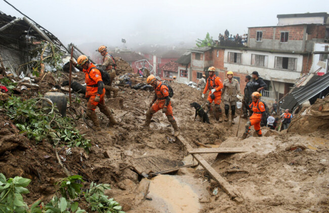 rescue-workers-walk-at-a-site-of-a-mudslide-at-morro-da-oficina-after-pouring-rains-in-petropolis-brazil-february-16-2022-reutersricardo-moraes