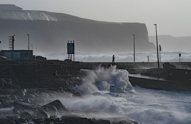 a-person-watches-waves-in-doolin-in-county-clare-on-the-west-coast-of-ireland-picture-date-sunday-february-20-2022