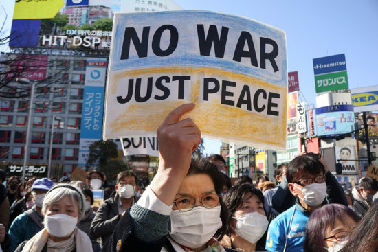 tokyo-japan-27th-feb-2022-a-woman-holding-a-placard-against-the-russian-invasion-of-ukraine-takes-part-during-a-protest-outside-shibuya-station-in-downtown-tokyo-japanese-supporters-including-po