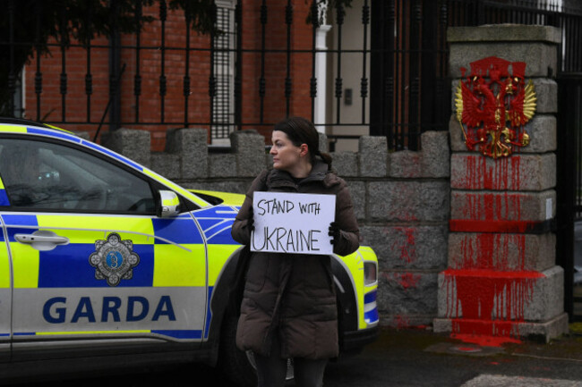 a-protester-holds-a-sign-outside-the-embassy-of-russia-after-it-was-defaced-with-red-paint-during-an-anti-war-protest-after-russian-president-vladimir-putin-authorised-a-military-operation-in-ukraine