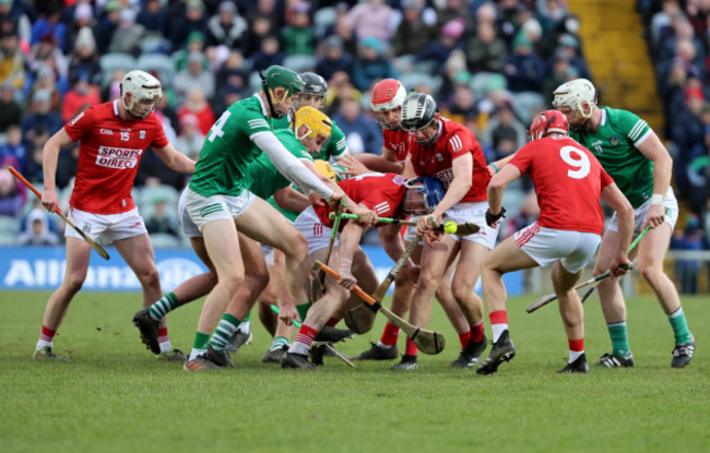 cork-and-limerick-players-struggle-to-control-the-ball