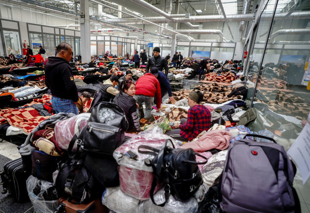 mlyny-poland-04th-mar-2022-refugees-sit-on-cots-after-arriving-at-the-refugee-collection-center-in-mlyny-a-former-shopping-center-just-a-few-kilometers-from-the-ukrainian-polish-border-in-korczow
