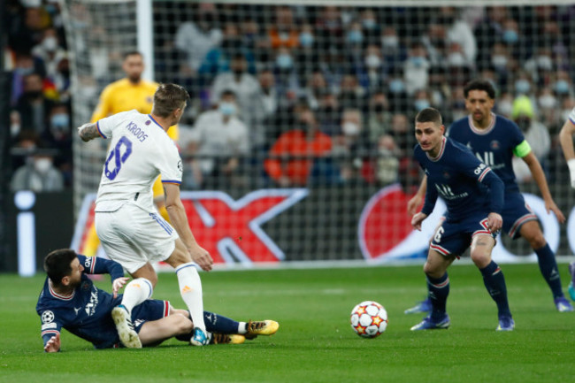 toni-kroos-of-real-madrid-and-lionel-messi-of-psg-in-action-during-the-uefa-champions-league-round-of-16-2nd-leg-football-match-between-real-madrid-and-paris-saint-germain-on-march-9-2022-at-santia