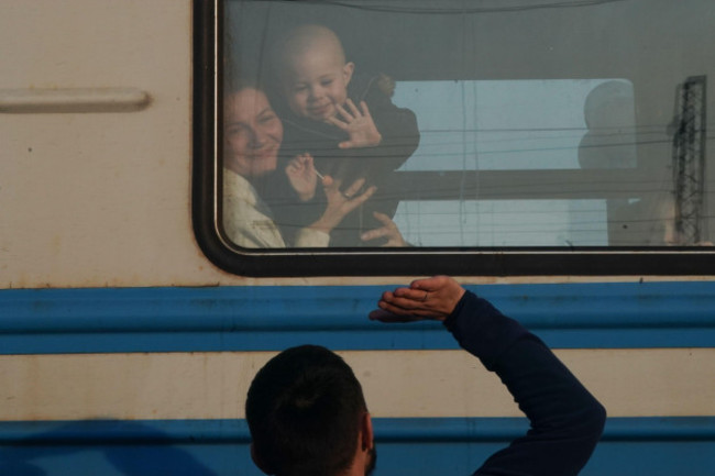 lviv-ukraine-15th-mar-2022-a-father-waves-goodbye-to-his-family-as-ukrainian-refugees-board-a-train-bound-for-przemsyl-poland-from-the-lviv-railway-station-on-march-15-2022-in-ukraine-nearly-3