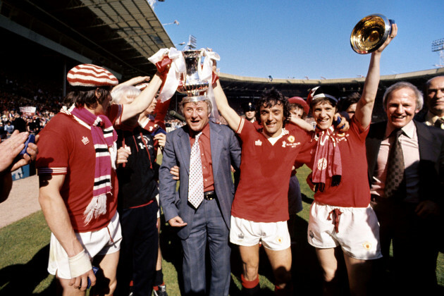 manchester-united-manager-tommy-docherty-with-the-fa-cup-trophy-on-his-head