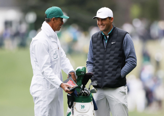augusta-united-states-09th-apr-2022-scottie-scheffler-and-caddie-andrew-land-ii-wait-to-hit-an-approach-shot-on-the-1st-hole-in-the-third-round-of-the-masters-golf-tournament-at-augusta-national-g