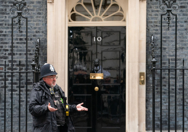 a-police-officer-gestures-to-colleagues-outside-10-downing-street-in-westminster-london-prime-minister-boris-johnson-and-chancellor-rishi-sunak-have-been-told-they-will-be-fined-as-part-of-a-police