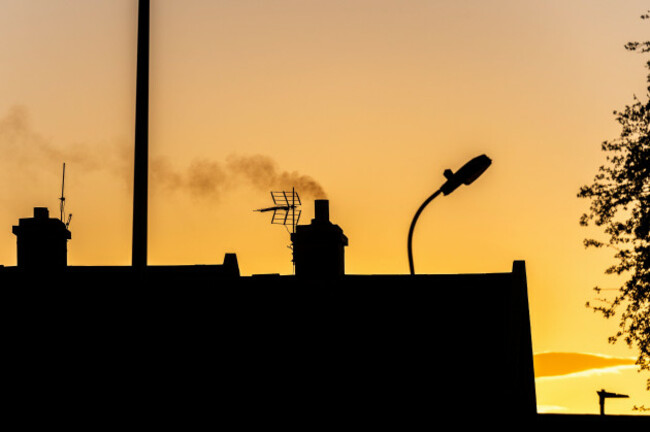 smoke-rising-from-a-house-chimney-in-ireland-at-sunset