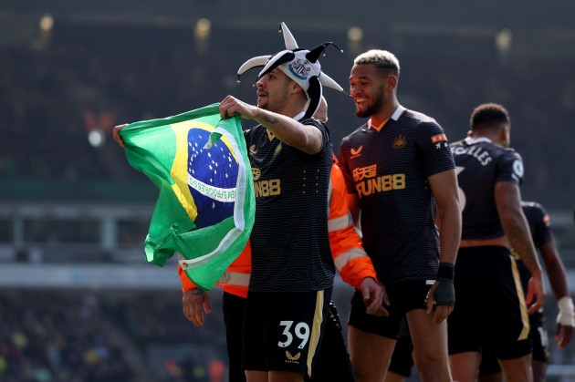 carrow-road-norwich-norforlk-uk-23rd-apr-2022-premier-league-football-norwich-versus-newcastle-bruno-guimaraes-of-newcastle-united-celebrates-with-a-brazilian-flag-and-newcastle-hat-after-he-s