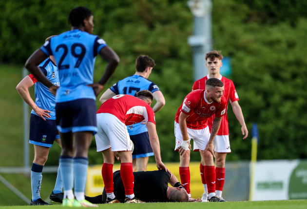 referee-dave-dunne-goes-down-after-being-hit-by-a-ball