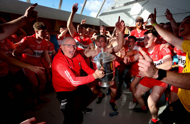 colin-mcguigan-celebrates-with-the-trophy-in-the-dressing-room