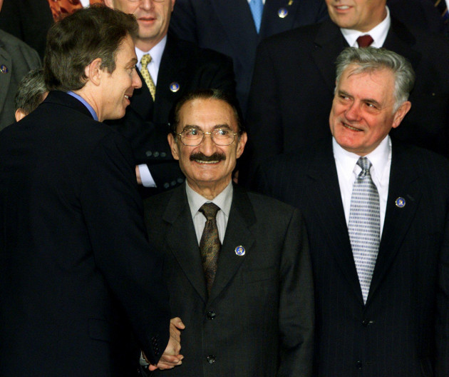 turkish-prime-minister-buerent-ecevit-c-is-welcomed-by-british-prime-minister-tony-blair-l-as-lithuanian-president-valdus-adamkus-r-looks-on-during-a-family-photo-with-leaders-and-foreign-minist