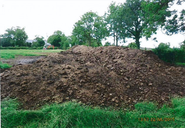 A large mound of poultry manure left in a field