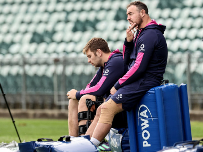 iain-henderson-and-rob-herring-watch-on-during-the-training