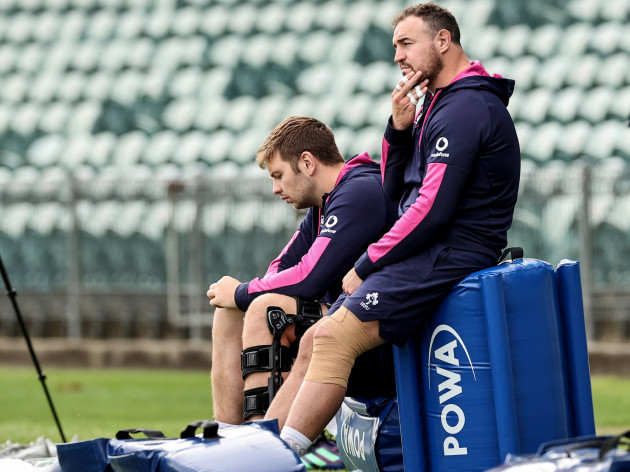 iain-henderson-and-rob-herring-watch-on-during-the-training