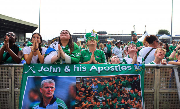 limerick-fans-stand-in-front-of-a-sign-that-reads-john-and-his-apostles