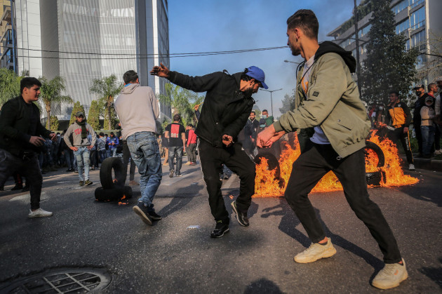 beirut-lebanon-24th-feb-2021-anti-government-activists-burn-car-tires-during-a-protest-near-the-house-of-a-military-tribunal-prosecutor-who-charged-several-protesters-with-terror-and-theft-offence