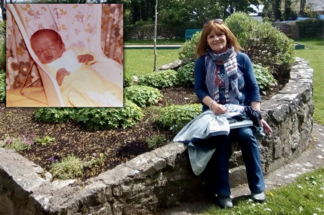 Terri Harrison sitting on a stone wall garden in the shape of a heart wearing a blue jumper, scarf and jeans with a coat on her lap. The inset photo is of a very small baby lying in a baby chair with his eyes closed.