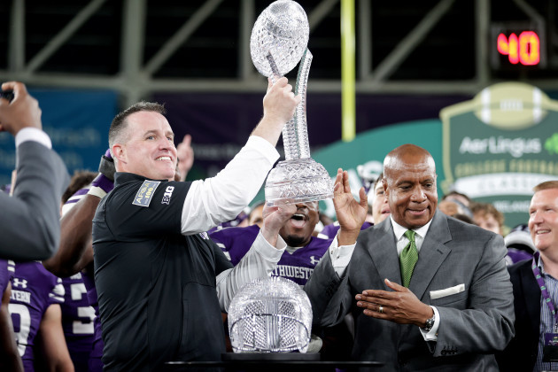 pat-fitzgerald-celebrates-with-the-keough-naughton-college-memorial-football-trophy-after-the-game