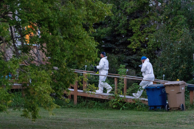 investigators-with-protective-equipment-enter-a-house-in-a-crime-scene-in-weldon-sask-sunday-sept-4-2022-saskatchewan-rcmp-has-confirmed-that-there-are-10-dead-while-15-are-injured-following-th