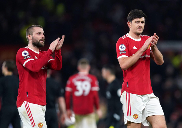 manchester-uniteds-luke-shaw-and-harry-maguire-applaud-the-fans-after-the-final-whistle-following-the-premier-league-match-at-old-trafford-manchester-picture-date-tuesday-february-15-2022