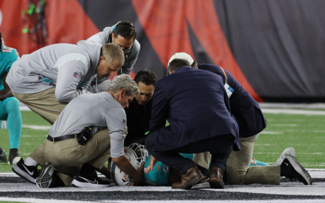 cincinnati-united-states-29th-sep-2022-miami-dolphins-quarterback-tua-tagovailoa-1-is-taken-off-the-field-after-he-was-sacked-by-cincinnati-bengals-josh-tupou-68-during-the-first-half-of-play