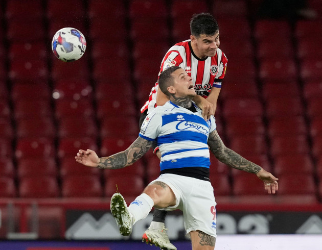 sheffield-england-4th-october-2022-john-egan-of-sheffield-utd-gets-above-lyndon-dykes-of-qpr-during-the-sky-bet-championship-match-at-bramall-lane-sheffield-picture-credit-should-read-andrew-ya