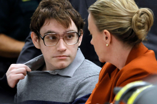 fort-lauderdale-florida-usa-13th-oct-2022-marjory-stoneman-douglas-high-school-shooter-nikolas-cruz-tugs-at-his-shirt-collar-as-he-is-seated-at-the-defense-table-before-the-verdict-in-his-sentenc