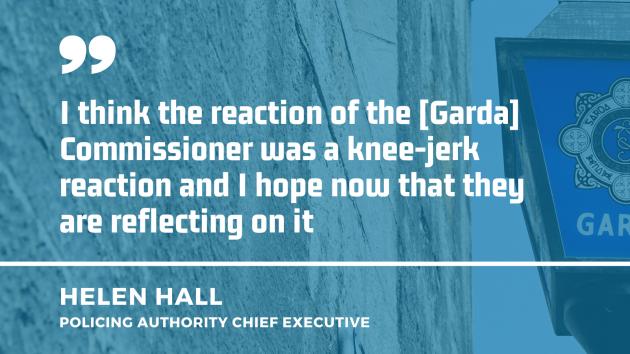 Garda station sign in the background with quote by Helen Hall, chief executive of the Policing Authority - I think the reaction of the Commissioner was a knee-jerk reaction and I hope now that they are reflecting on it