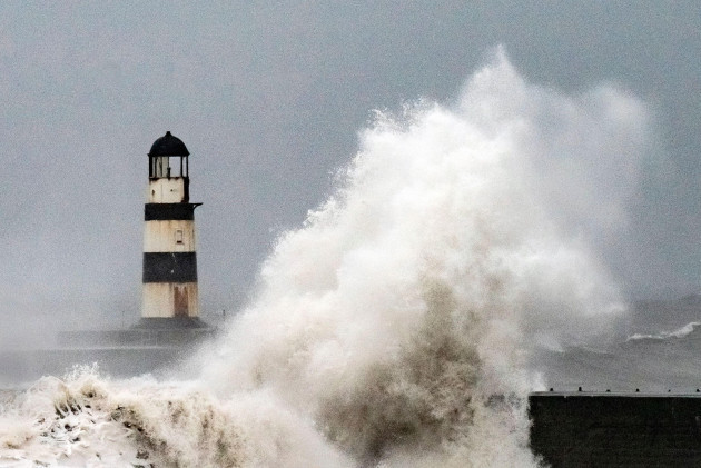 waves-crash-against-the-lighthouse-in-seaham-harbour-county-durham-motorists-are-being-warned-to-stay-off-the-roads-as-cars-have-become-stuck-in-flood-water-caused-by-downpours-and-the-uk-prepares-t