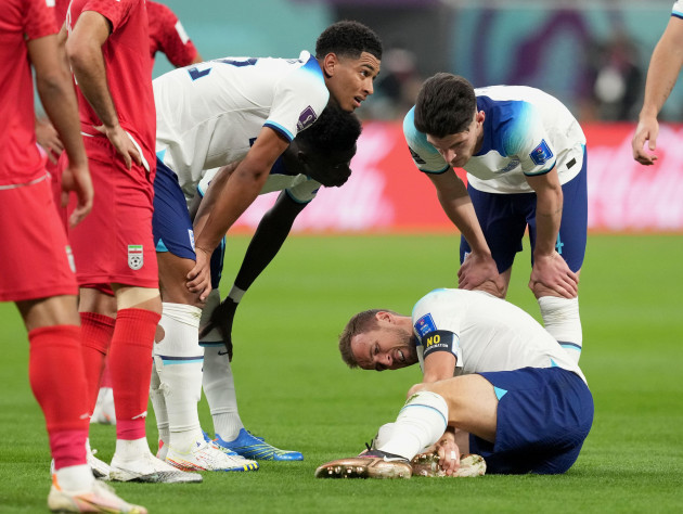englands-harry-kane-holds-his-ankle-after-a-challenge-during-the-fifa-world-cup-group-b-match-at-the-khalifa-international-stadium-in-doha-qatar-picture-date-monday-november-21-2022