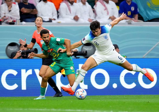 assistant-referee-kathryn-nesbitt-looks-on-as-senegals-iliman-ndiaye-and-englands-harry-maguire-battle-for-the-ball-during-the-fifa-world-cup-round-of-sixteen-match-at-the-al-bayt-stadium-in-al-khor