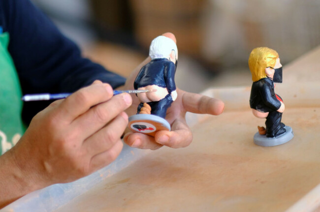a-worker-paints-a-u-s-democratic-presidential-candidate-joe-biden-caganer-in-a-pottery-in-torroella-de-montgri-near-girona-spain-october-20-2020-reutersnacho-doce