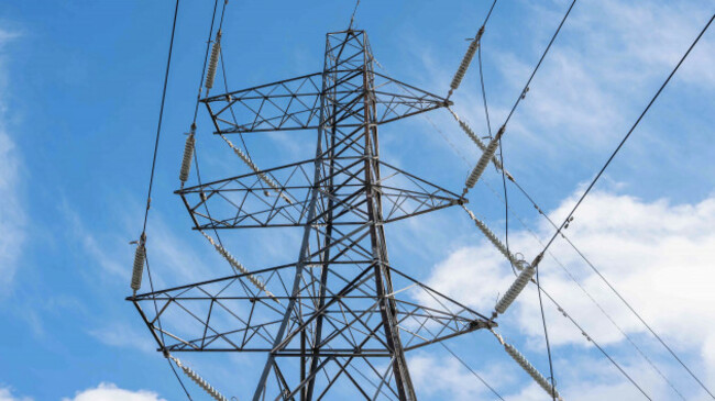 Large metal electricity pylon with six wires across three levels 