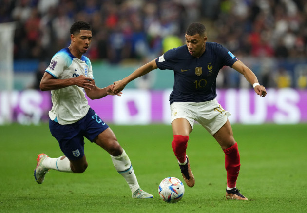englands-jude-bellingham-left-and-frances-kylian-mbappe-battle-for-the-ball-during-the-fifa-world-cup-quarter-final-match-at-the-al-bayt-stadium-in-al-khor-qatar-picture-date-saturday-december