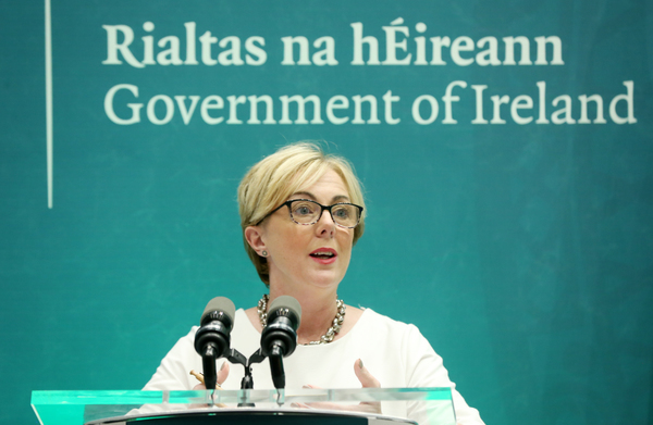 Regina Doherty at a Government of Ireland - Rialtas na hÉireann - event speaking at a podium