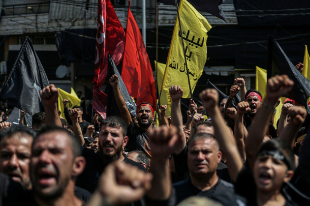 beirut-lebanon-09th-aug-2022-supporters-of-hezbollah-the-lebanese-pro-iranian-shia-islamist-political-group-parade-during-a-mass-rally-at-beiruts-southern-suburb-to-mark-ashura-a-day-on-which