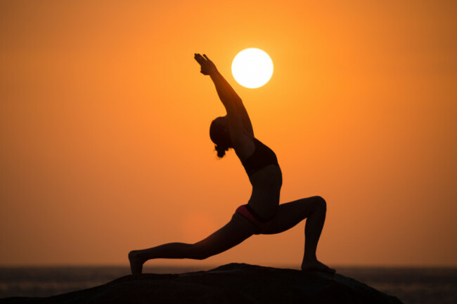 warriorposefromyogabywomansilhouetteonsunset