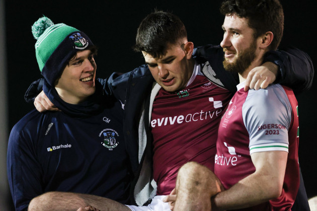 tomo-culhane-centre-is-carried-off-the-pitch-by-teammates-james-webb-and-eoghan-kelly-after-the-game